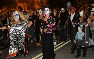 Costumed participants in All Souls Procession march through Tucson